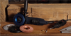 Angle grinder with various abrasive discs and a rotary tool on a wooden workbench with rough timber background