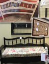 Before and after images of a wooden bench frame refinished from natural wood to black paint with a patterned cushion added.