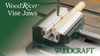 Bench vise with WoodRiver aluminum vise jaws holding a wooden dowel for drilling.