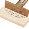 Branding iron with wooden handle stamping WOODCRAFT SUPPLY PO BOX 1686 on a wood piece