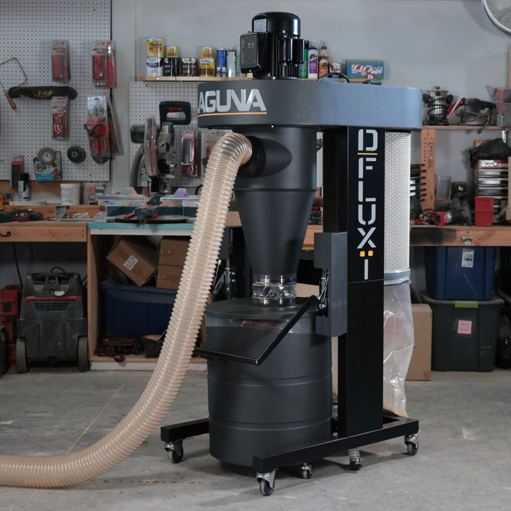 Laguna D:FLUX cyclone dust collector staged in a home woodshop with hose extended.