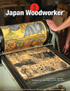 Hand turning a woodblock printing press roller with detailed carved woodblock print in workshop setting