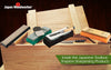 Assorted Shapton sharpening stones and a chisel displayed on a wooden toolbox lid