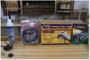 Airbrush compressor, mini spray gun set, and airbrush kit displayed on workshop bench
