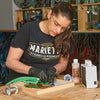 Stained glass craftsman Aisha Moghal in her studio working on a stained glass project.