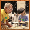 Experienced woodturner instructing youth on lathe safety and spindle turning technique