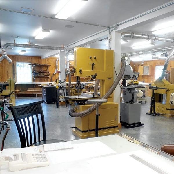 A clean woodworking shop, with well laid-out dust collection.