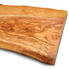 Close-up of a polished olivewood slab showing natural grain patterns and live edge.