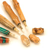 Hand-turned wooden perfume applicators with removable caps showing wood grain and finish variations