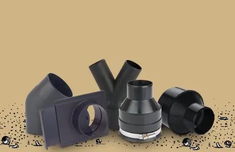 Set of black plastic ducting components on a beige background