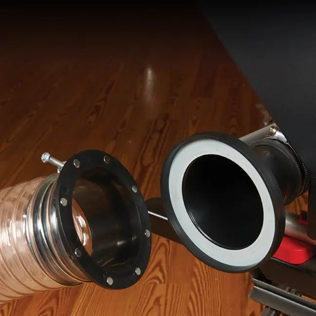 Close-up of a flexible metal duct with connectors on a wooden surface