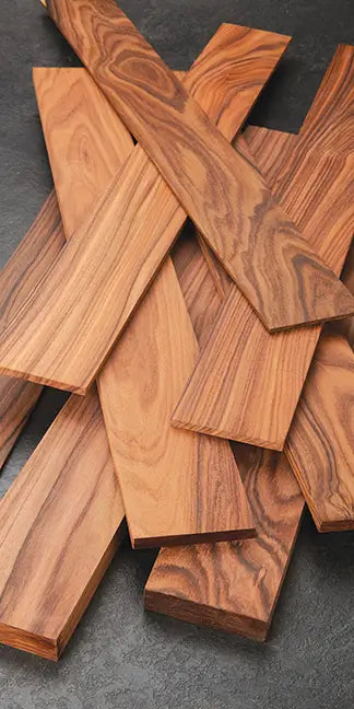 Stack of wooden planks on a dark surface