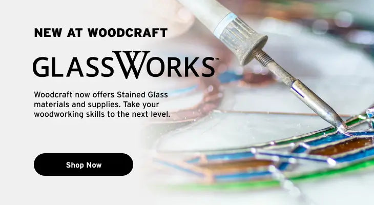 Promotional graphic for Woodcraft's GlassWorks featuring a close-up of a soldering tool working on a stained glass panel, with text reading 'NEW AT WOODCRAFT GLASSWORKS' and a 'Shop Now' button.