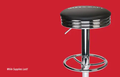 Bar stool with black cushioned seat on a red background